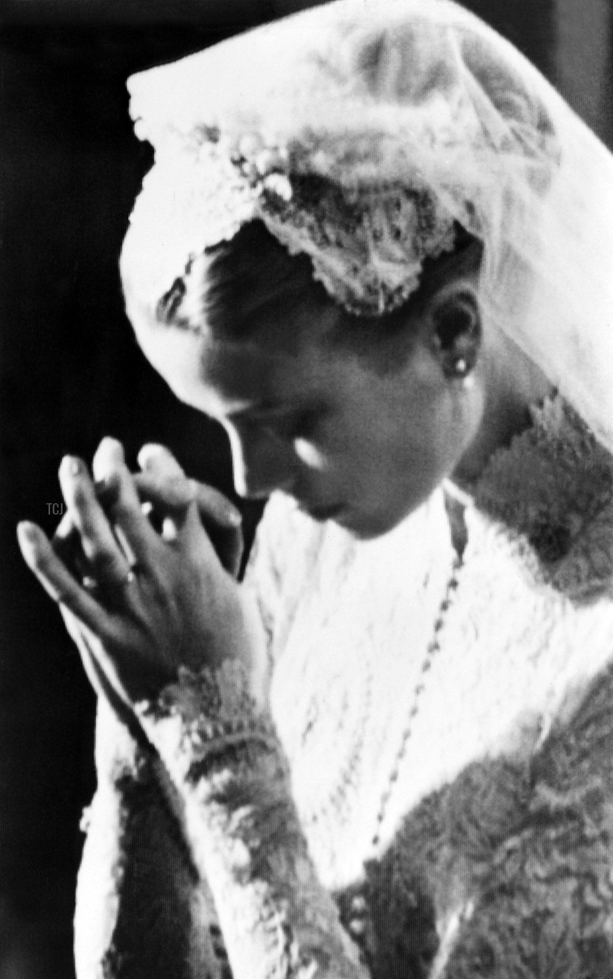 Grace Kelly prays during her wedding to Prince Rainier III of Monaco at Monaco's Saint Nicholas Cathedral on April 19, 1956 (AFP via Getty Images)