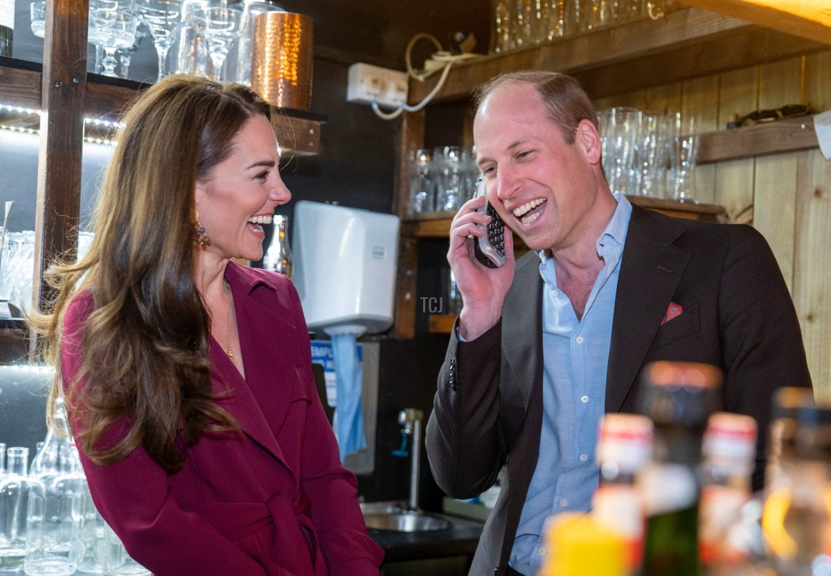 The Prince and Princess of Wales smile as they take a booking from a member of the public during a visit to The Indian Streatery in Birmingham on April 20, 2023 (ARTHUR EDWARDS/POOL/AFP via Getty Images)