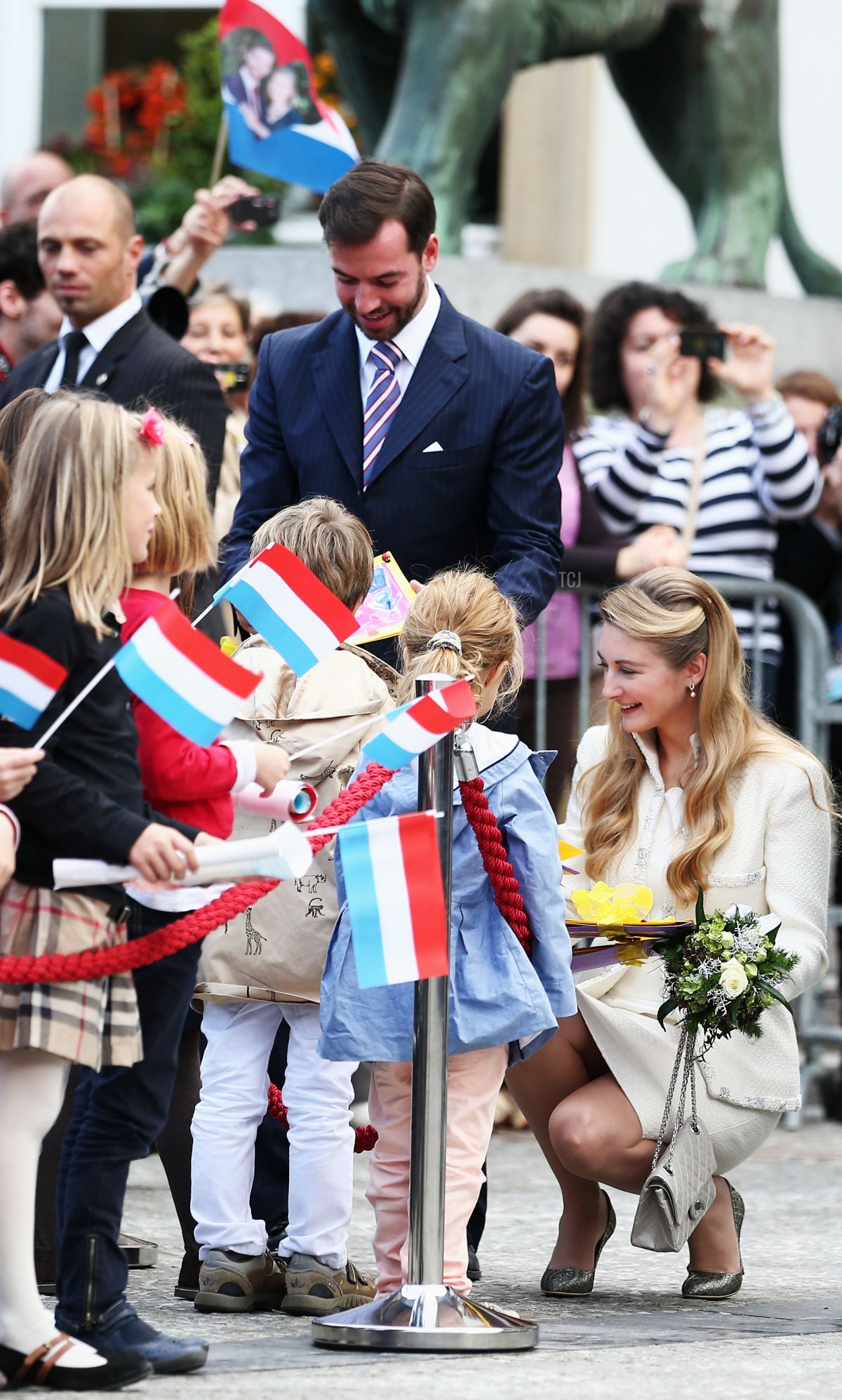 Hereditary Grand Duke Guillaume of Luxembourg and Countess Stephanie de Lannoy greet children gathered outside the Hotel de Ville, where the couple were married in a civil ceremony on October 19, 2012 in Luxembourg (Andreas Rentz/Getty Images)
