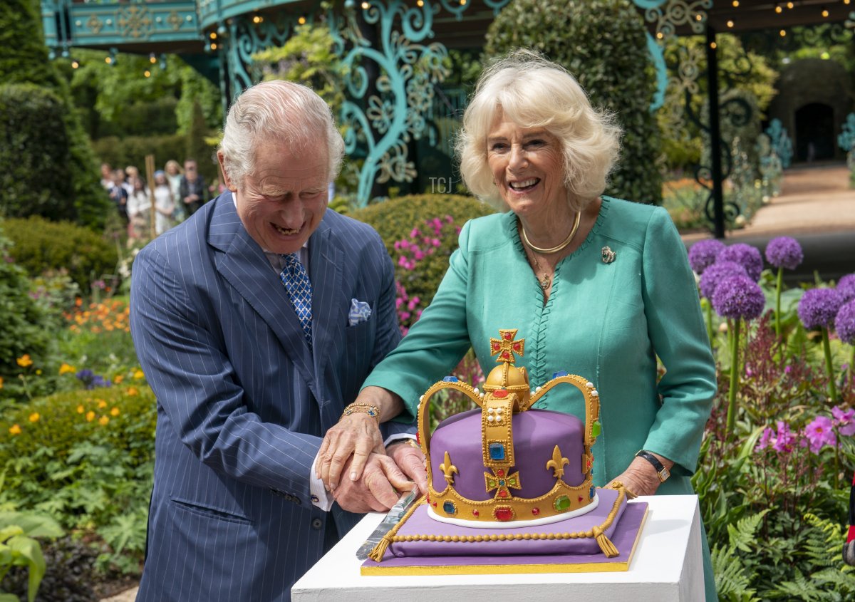 King Charles III and Queen Camilla cut a cake during a visit to open the new Coronation Garden on day one of their two-day visit to Northern Ireland on May 24, 2023 in Newtownabbey, Northern Ireland (Arthur Edwards - Pool/Getty Images)