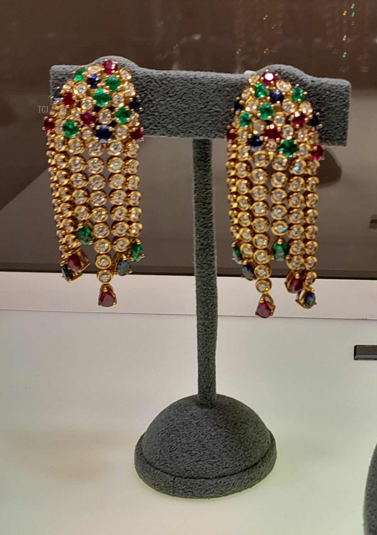 The earrings from a demi-parure of Köchert jewels, made of diamonds, emeralds, sapphires, and rubies set in yellow gold, from the Heidi Horten collection sold at Christie's (Photo © Thomas. Do not reproduce.)