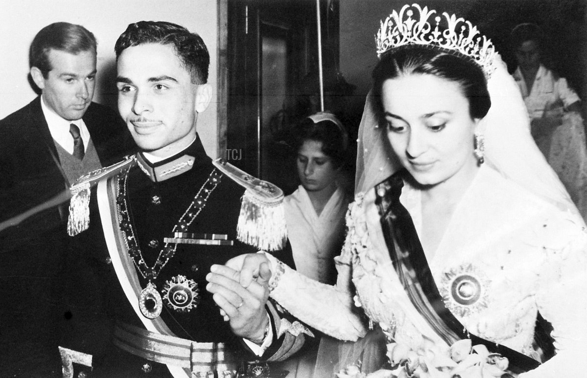 King Hussein of Jordan holds the hand of his bride, Princess Dina, during their wedding in Amman on April 22, 1955 (AFP via Getty Images)
