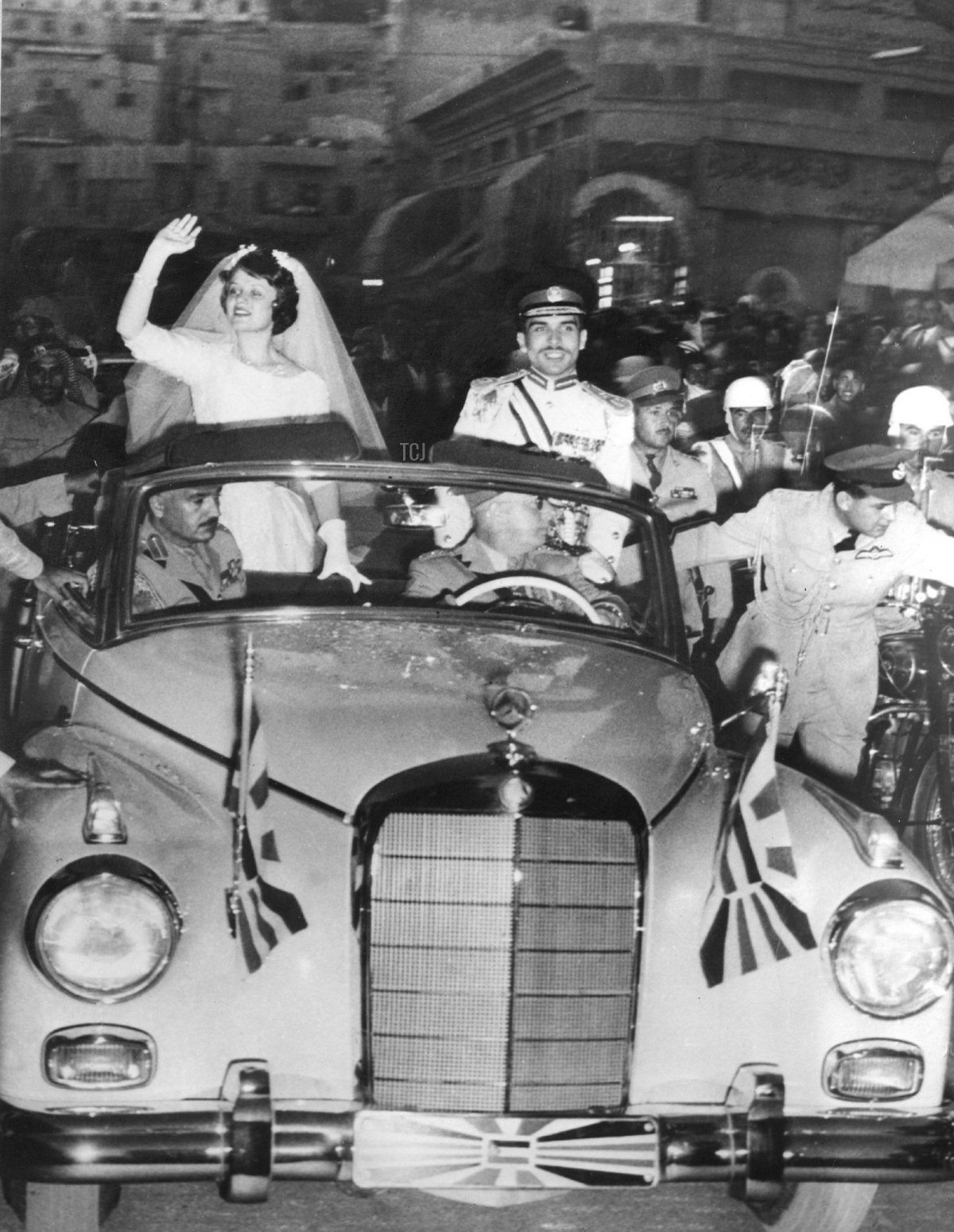 King Hussein and Princess Muna of Jordan drive through the streets of Amman after their wedding ceremony on May 25, 1961 (AFP via Getty Images)