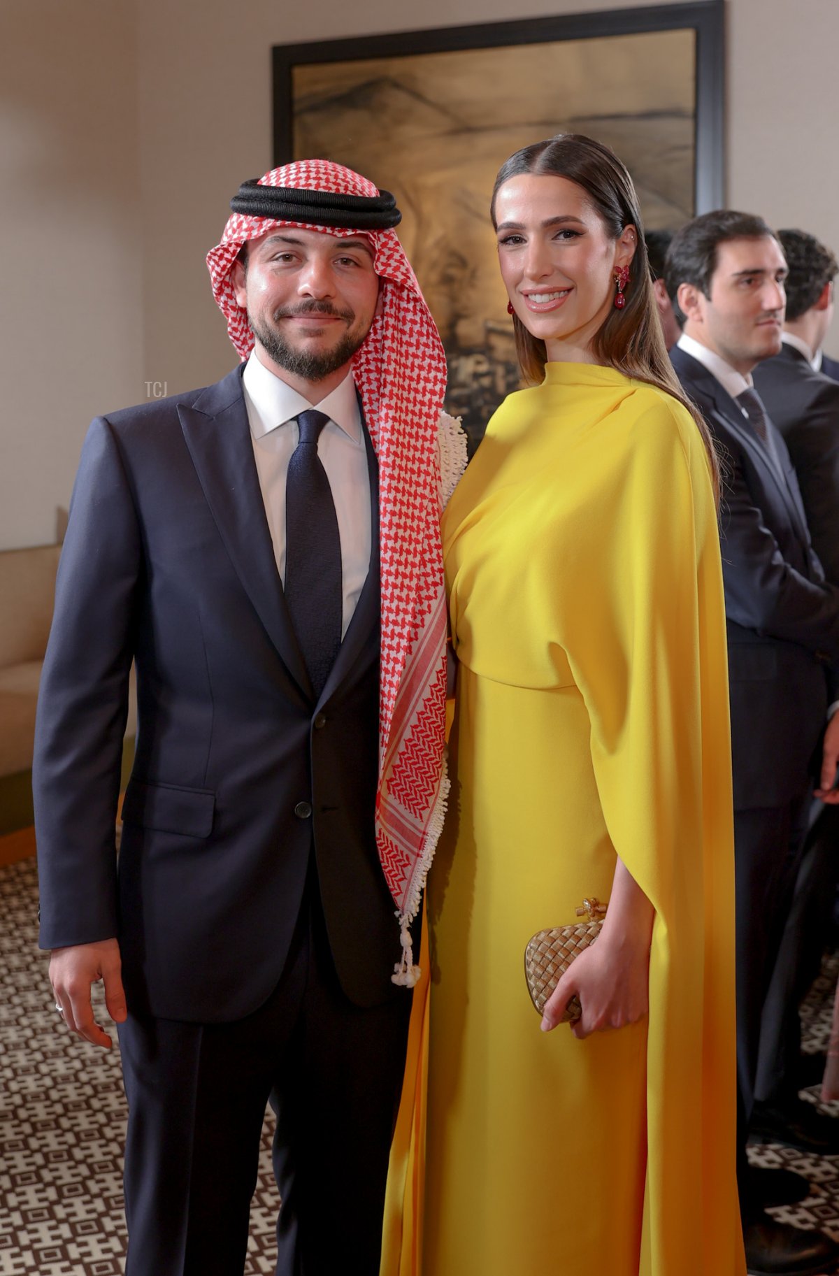 Crown Prince Hussein of Jordan is pictured with his fiancée, Rajwa Al Saif, during the wedding of his sister, Princess Iman, in Amman on March 12, 2023 (Handout/Jordanian Royal Court/Getty Images)