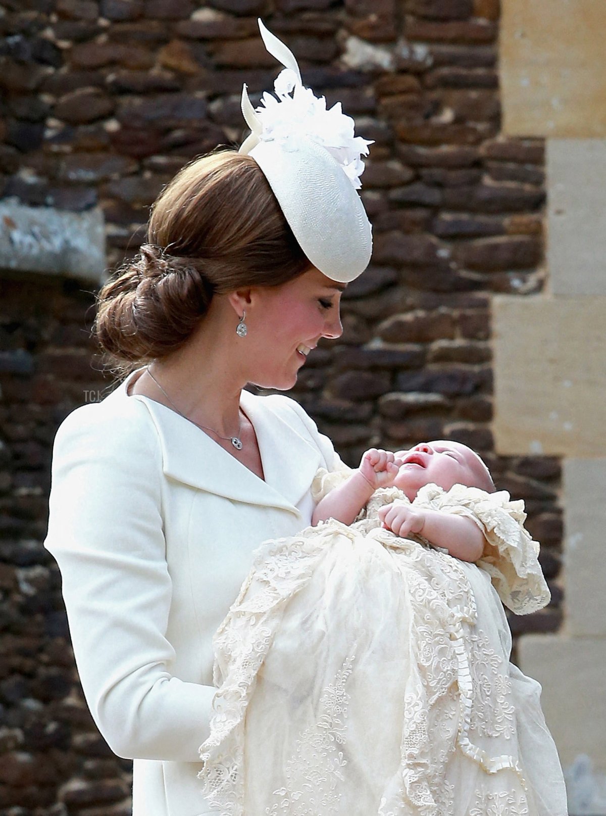 The Duchess of Cambridge carries her daughter, Princess Charlotte of Cambridge, as they arrive for the baby's christening at St. Mary Magdalene Church in Sandringham, England, on July 5, 2015 (CHRIS JACKSON/POOL/AFP via Getty Images)