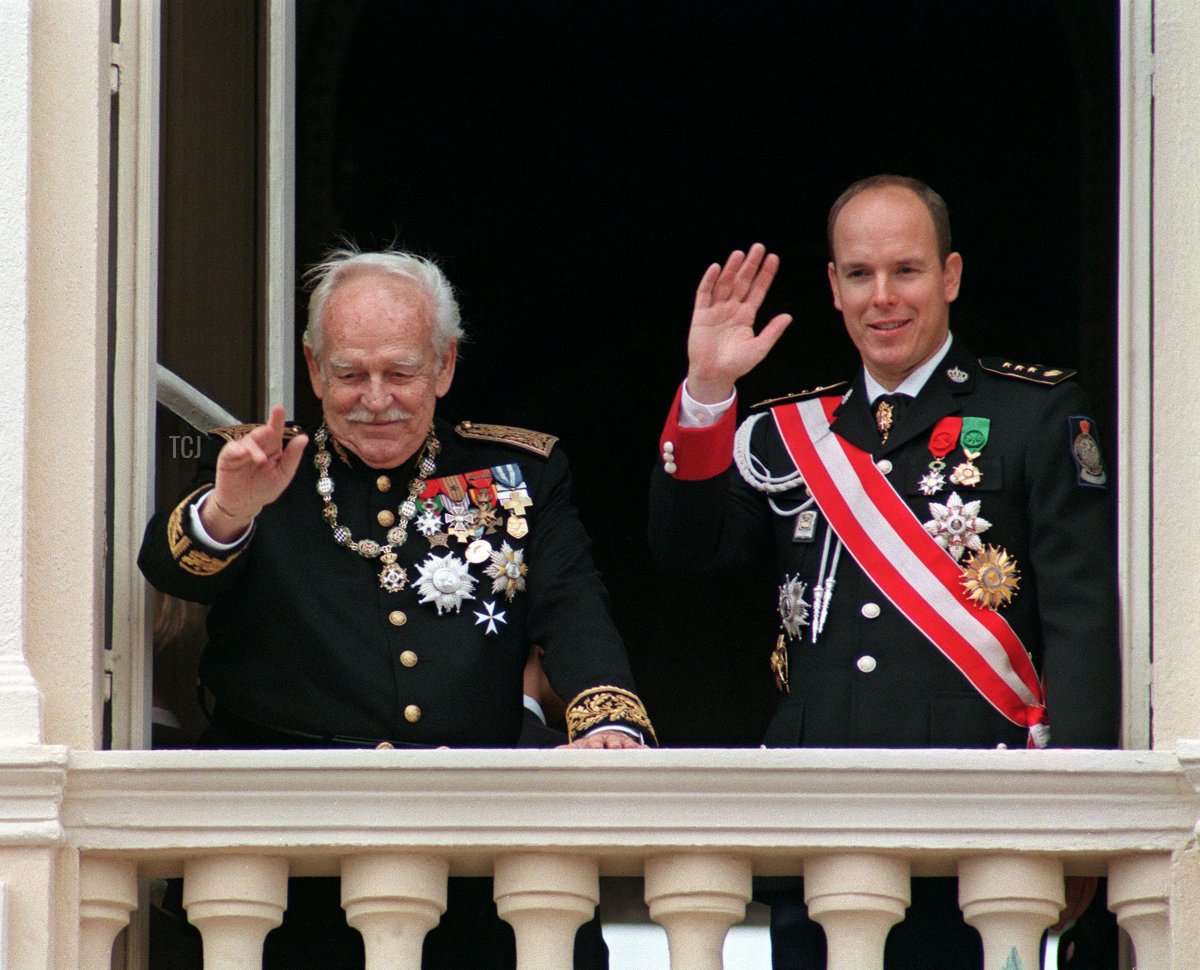 Prince Rainier III and Prince Albert of Monaco wave from the palace balcony on National Day, November 19, 1997 (PATRICK HERTZOG/AFP via Getty Images)