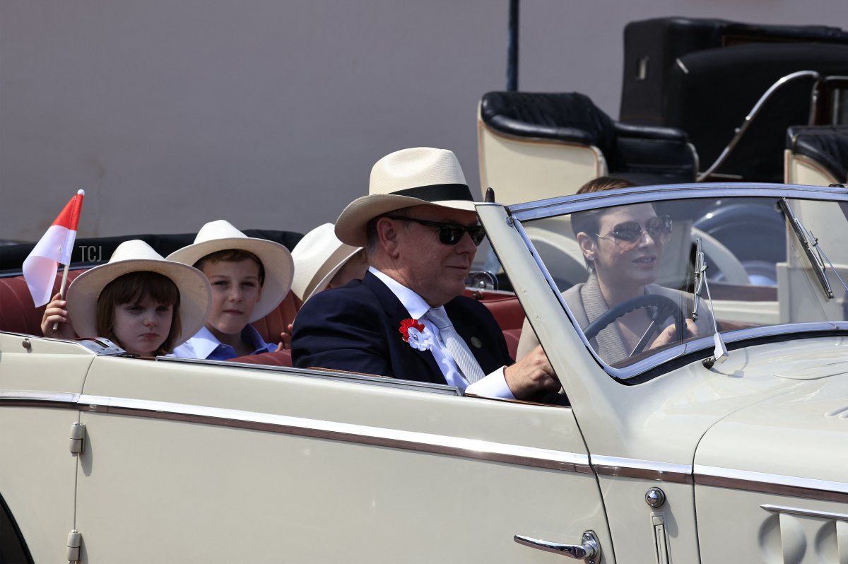 Prince Albert II and Princess Charlene of Monaco, with their children and nephew, take part in a parade of vintage cars during celebrations to mark the centenary of the birth of the late Prince Rainier III in Monaco on May 31, 2023 (VALERY HACHE/POOL/AFP via Getty Images)