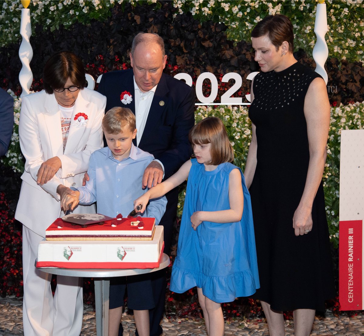 Princess Stephanie of Monaco, Prince Jacques of Monaco, Prince Albert II of Monaco, Princess Gabriella of Monaco, and Princess Charlene of Monaco cut a cake as part of the celebration to mark the centenary of the birth of the late Prince Rainer III on May 31, 2023 in Monaco (Pierre Villard - Pool/Getty Images)