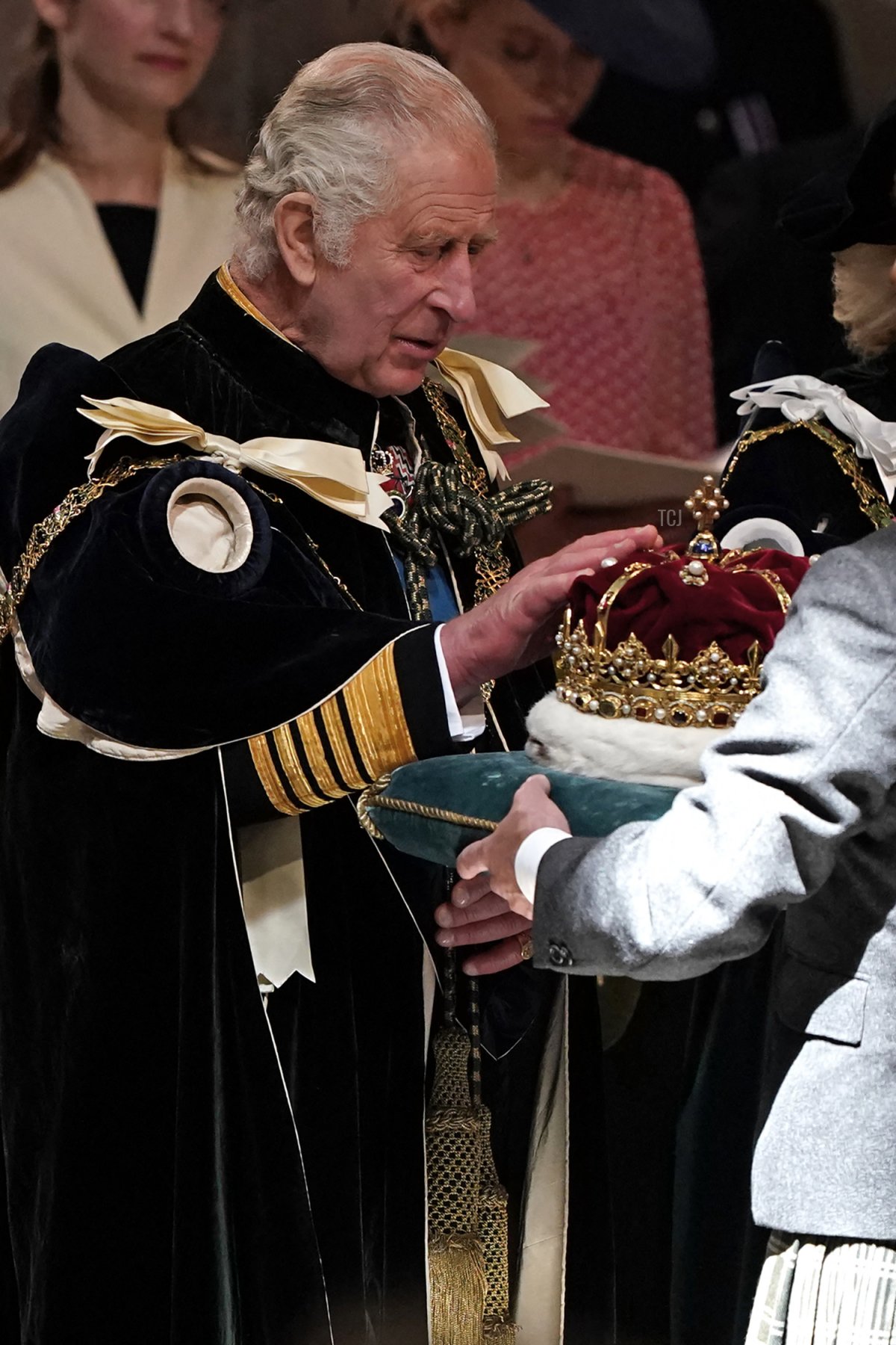 King Charles III touches the Crown of Scotland during a service of thanksgiving and dedication at St Giles' Cathedral in Edinburgh on July 5, 2023 (ANDREW MILLIGAN/POOL/AFP via Getty Images)
