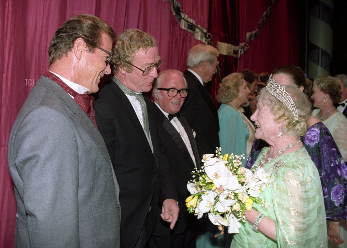 The Queen Mother meets Roger Moore, Michael Caine, and Sir Richard Attenborough after a 90th birthday gala in her honor at the London Palladium, July 19, 1990 (Martin Keene/PA Images/Alamy)