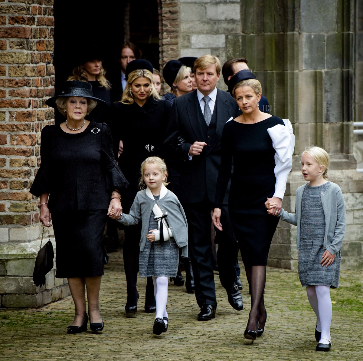 Princess Beatrix, Queen Maxima, Countess Zaria, Princess Laurentien, King Willem-Alexander, Princess Mabel, and Countess Luana attend a memorial for the late Prince Friso in Delft on November 2, 2013 (ROBIN VAN LONKHUIJSEN/AFP via Getty Images)