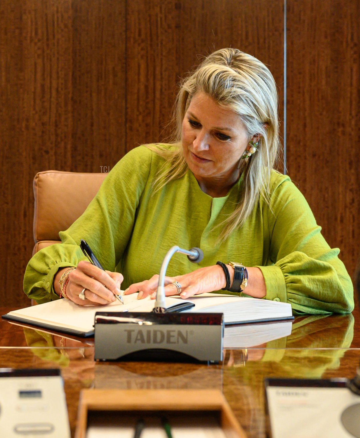 Queen Maxima of the Netherlands signs a book before meeting with United Nations Secretary General Antonio Guterres at UN headquarters in New York City on August 29, 2023 (ED JONES/AFP via Getty Images)