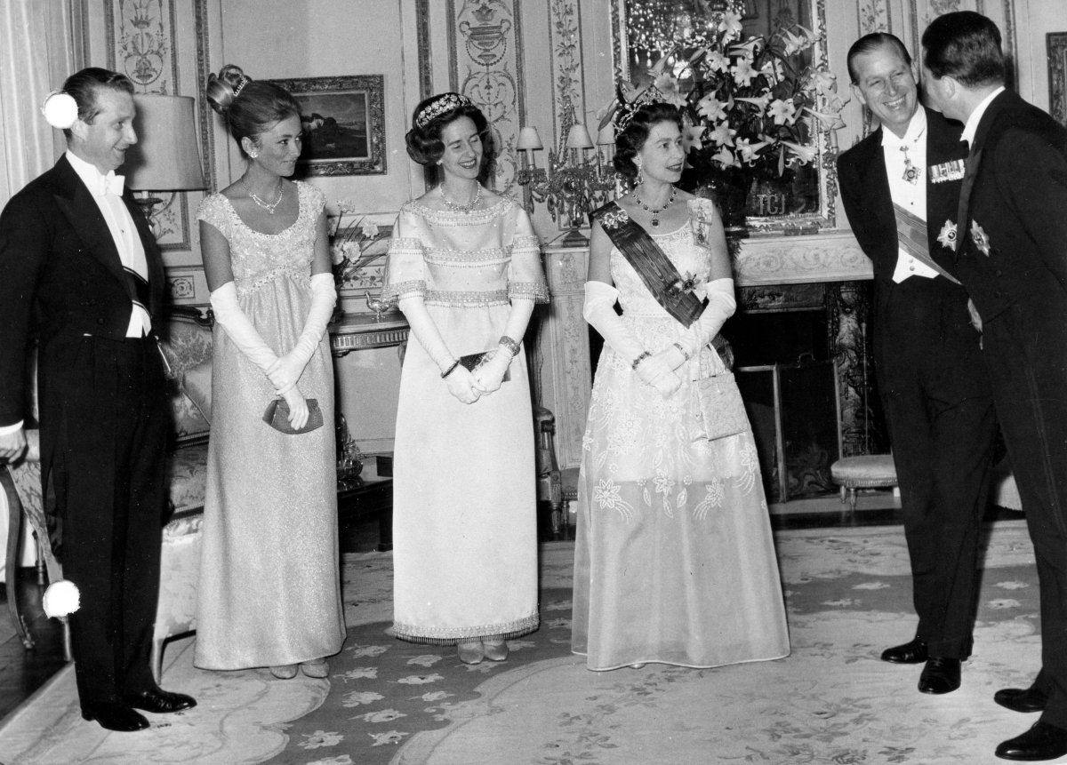 Prince Albert and Princess Paola of Belgium, Queen Fabiola of the Belgians, Queen Elizabeth II, Prince Philip, and King Baudouin of the Belgians attend a dinner at the British Embassy in Brussels, May 1966 (Belga News Agency/Alamy)