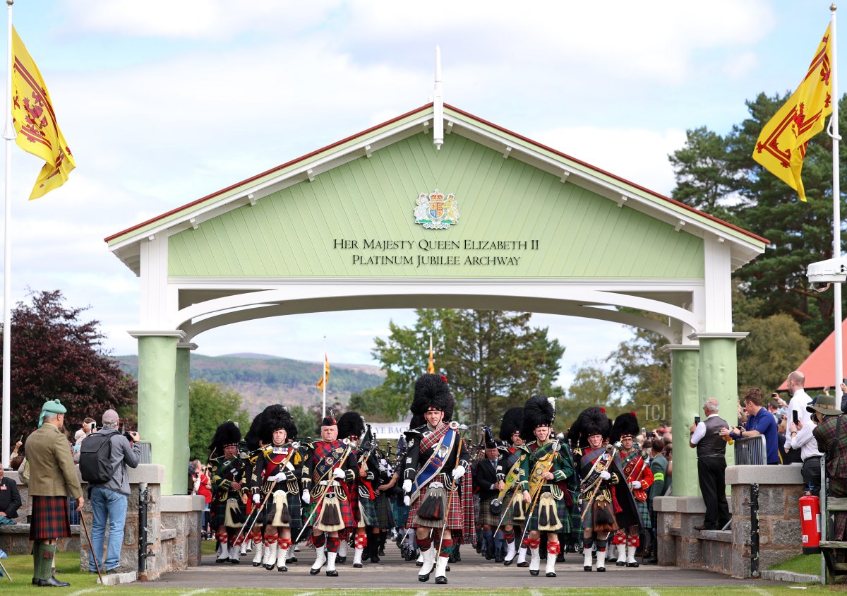 A pipe band makes their way under the Queen Elizabeth II Platinum Jubilee Archway at the Braemar Gathering at the Princess Royal and Duke of Fife Memorial Park in Braemar, Scotland, on September 02, 2023 (Chris Jackson/Getty Images)