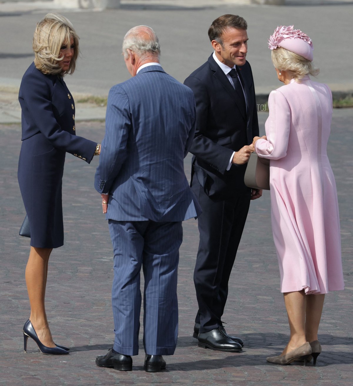 King Charles III and Queen Camilla of the United Kingdom are greeted by President Emmanuel Macron and his wife, Brigitte, during an official welcome ceremony at the start of a state visit to France on September 20, 2023 (THOMAS SAMSON/AFP via Getty Images)