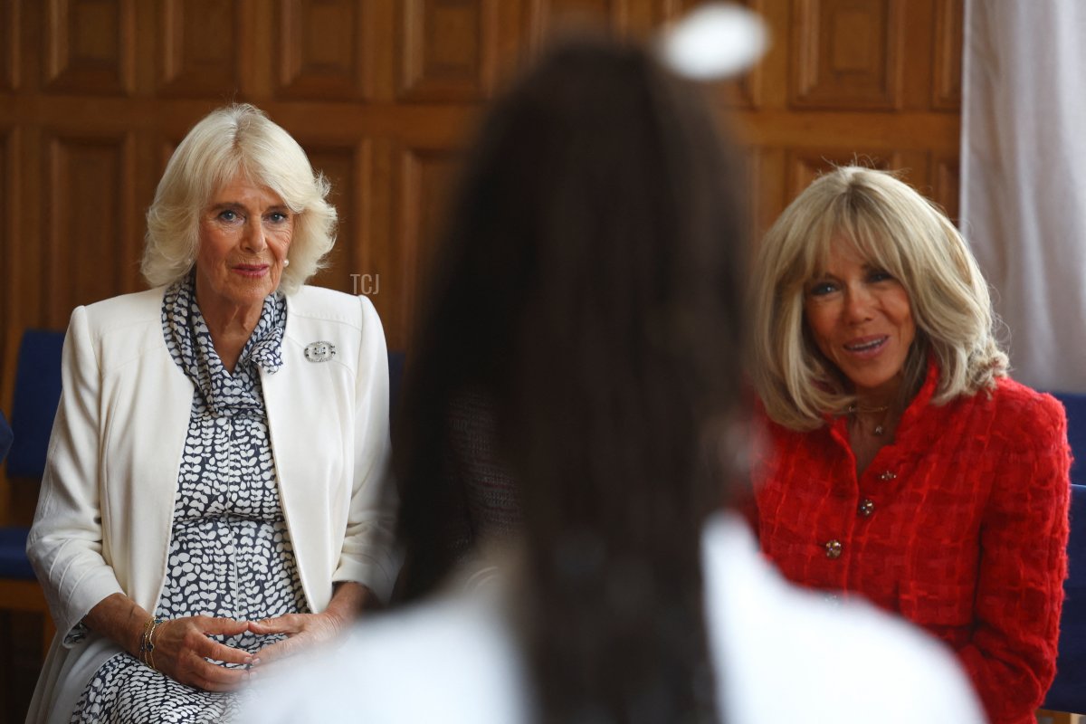 Queen Camilla of the United Kingdom and Brigitte Macron meet with members of La Maison des Femmes, an organization for victims of domestic abuse, in Saint-Denis near Paris during the British state visit to France, September 21, 2023 (Hannah McKay-Pool/Getty Images)