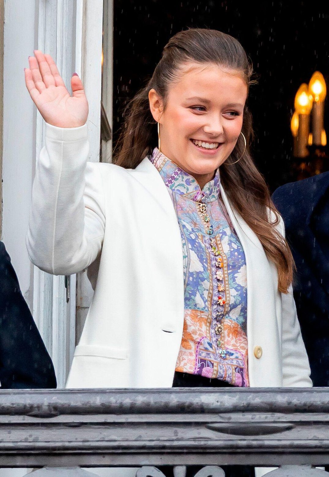 Princess Isabella of Denmark waves from the balcony of Amalienborg Palace during Prince Christian's 18th birthday celebrations in Copenhagen on October 15, 2023 (Patrick van Katwijk/DPA Picture Alliance/Alamy)