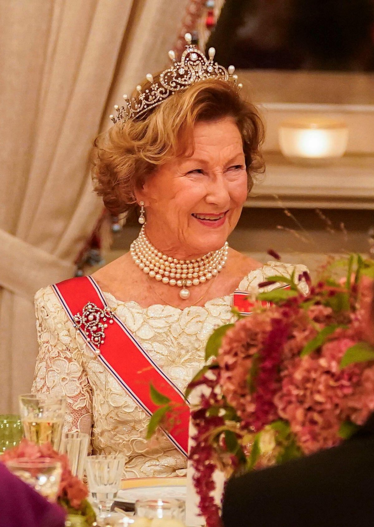 The Queen of Norway laughs as the Crown Prince of Norway delivers remarks during a gala dinner for representatives of the Storting at the Royal Palace in Oslo on October 26, 2023 (Terje Bendiksby/NTB/Alamy)