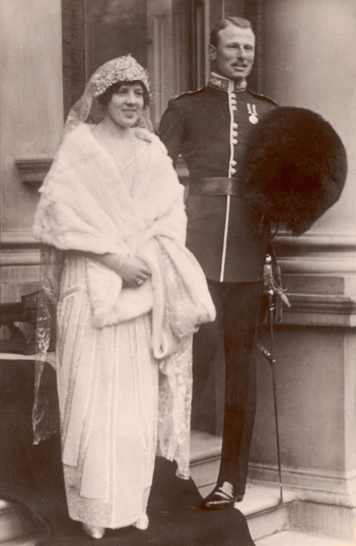 Princess Maud and Lord Carnegie are pictured on their wedding day outside her mother's home in Portman Square in London on November 12, 1923 (Chronicle/Alamy)