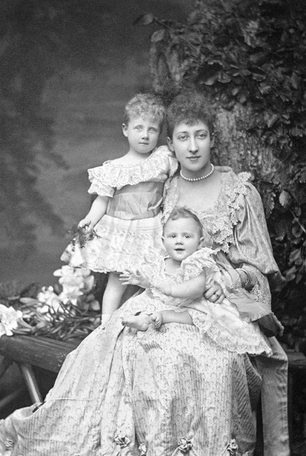 Princess Louise, Duchess of Fife poses with her daughters, Alexandra and Maud, in a photographic portrait taken by Alice Hughes, ca. 1894 (Royal Collection Trust)