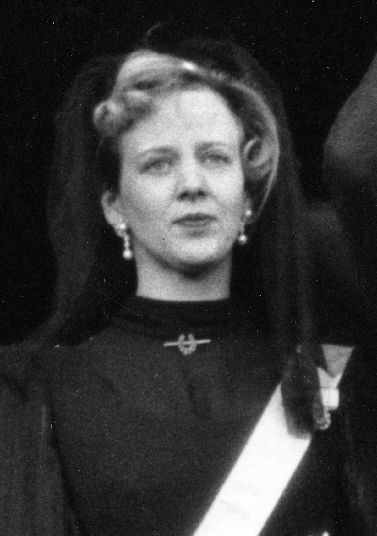 Queen Margrethe II of Denmark appears on the balcony of Christiansborg Palace in Copenhagen as Prime Minister Jens Otto Krag proclaims her accession, January 15, 1972 (Aage Sørensen/AFP via Getty Images)