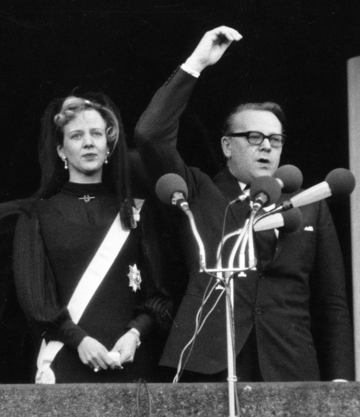 Queen Margrethe II of Denmark appears on the balcony of Christiansborg Palace in Copenhagen as Prime Minister Jens Otto Krag proclaims her accession, January 15, 1972 (Aage Sørensen/AFP via Getty Images)