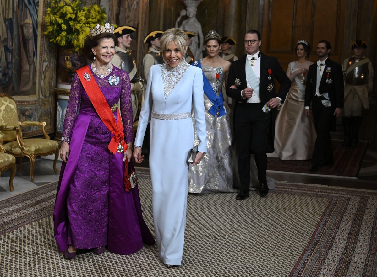 Queen Silvia of Sweden and Brigitte Macron arrive for a state banquet at the Royal Palace in Stockholm on January 30, 2024 (Jessica Gow/TT News Agency/Alamy)