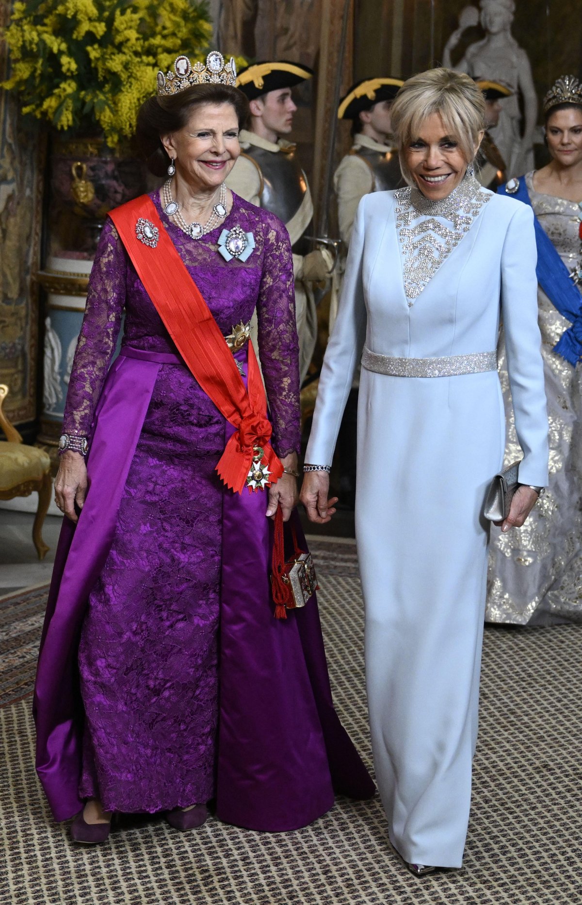 Queen Silvia of Sweden and Brigitte Macron arrive for a state banquet at the Royal Palace in Stockholm on January 30, 2024 (Jessica Gow/TT News Agency/Alamy)