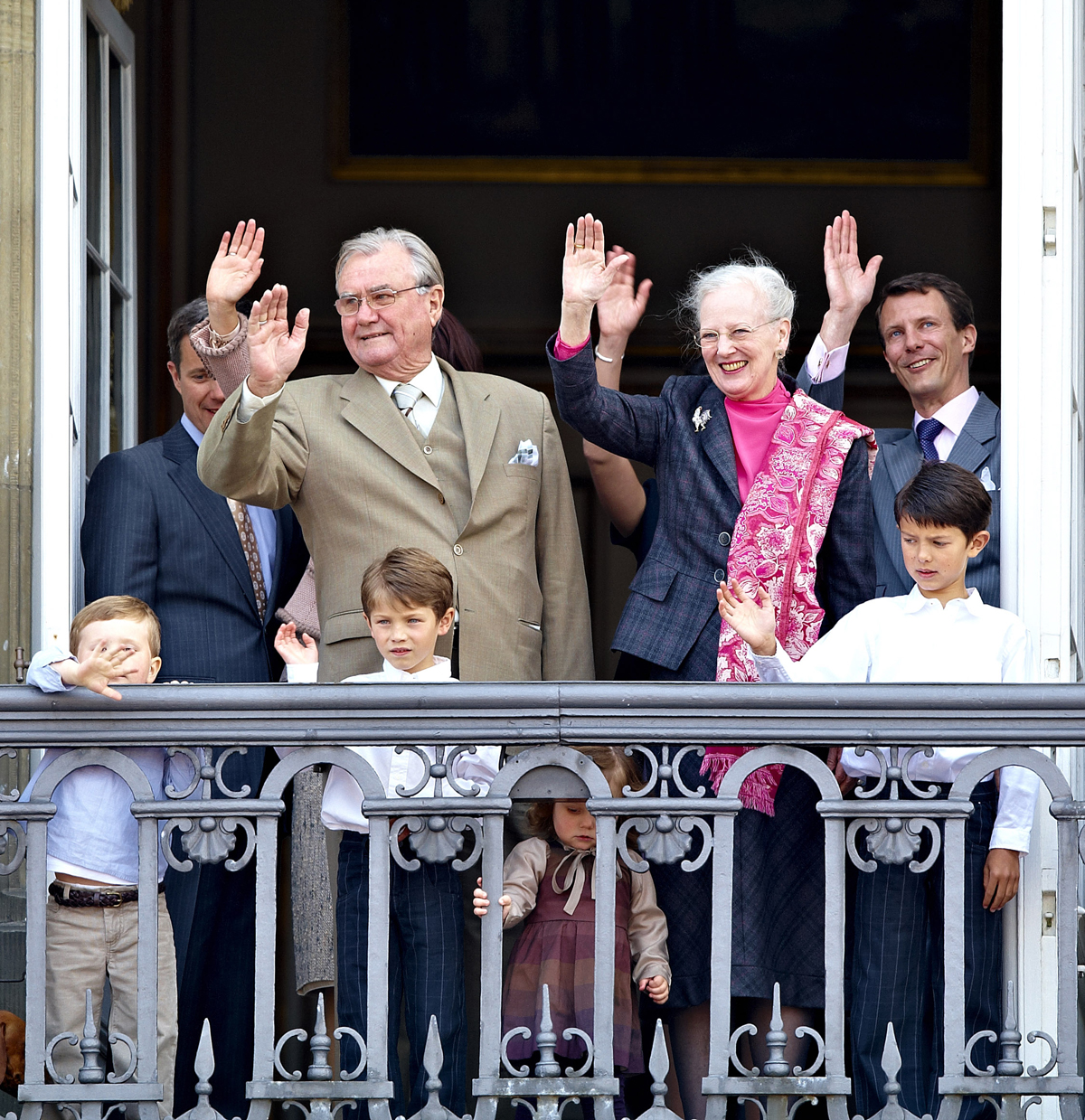 Queen Margrethe II and Prince Henrik of Denmark, with Crown Prince Frederik, Prince Joachim, Prince Nikolai, Prince Felix, Prince Christian, and Princess Isabella, wave from the balcony of Christian IX's Palace in the Amalienborg complex on the Queen's birthday, April 16, 2009 (Schiller Graphics/Getty Images)