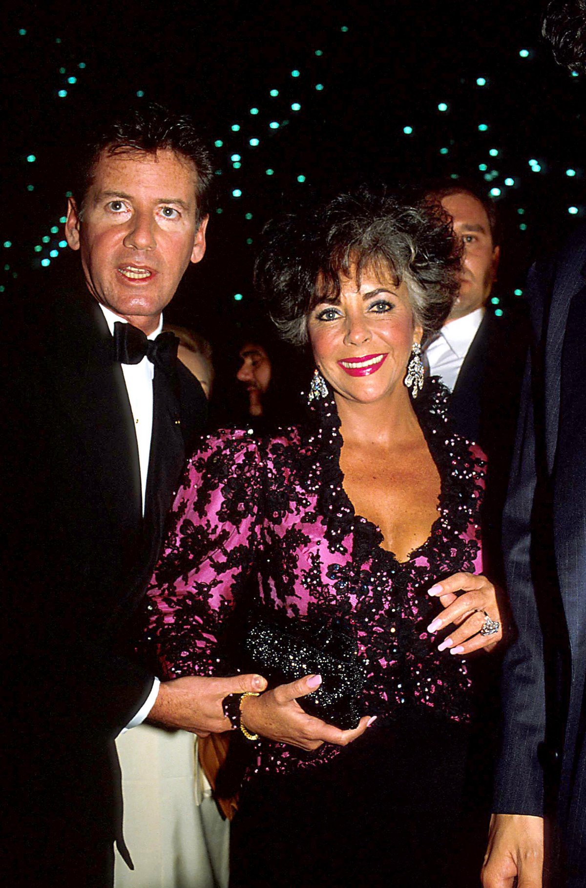 Calvin Klein and Elizabeth Taylor attend an amfAR reception at the Javits Center in New York, April 29, 1986 (ZUMA Press/Alamy)