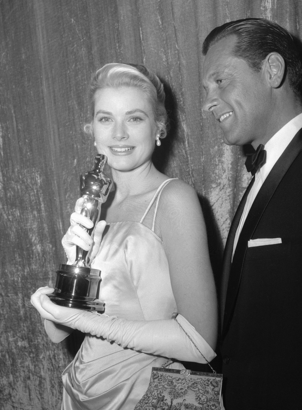 Grace Kelly, holding her Best Actress Oscar, poses backstage with William Holden after the 27th Annual Academy Awards at the Pantages Theatre in Hollywood on March 30, 1955 (Los Angeles Times Photographic Collection/UCLA Library)