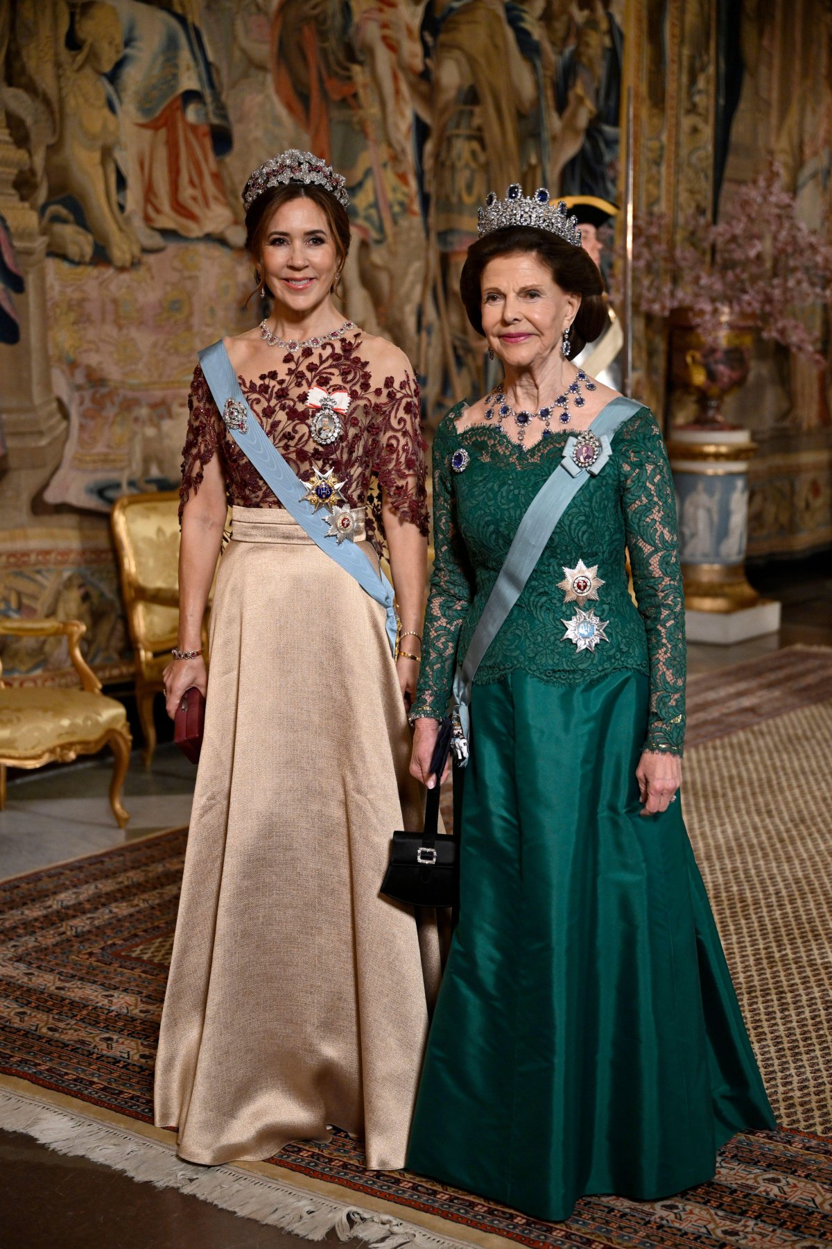 The Queen of Denmark and the Queen of Sweden attend a state banquet at the Royal Palace in Stockholm on May 6, 2024 (Pontus Lundahl/TT News Agency/Alamy)