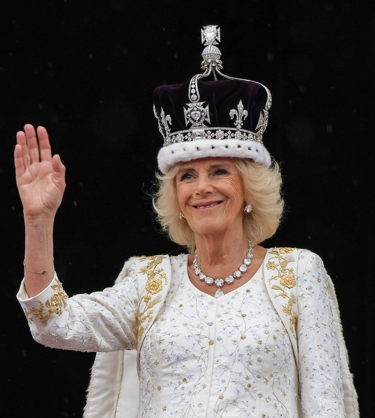 Queen Camilla of the United Kingdom waves from the balcony of Buckingham Palace in London after the coronation ceremony on May 6, 2024 (Julie Edwards/JEP News/Alamy)