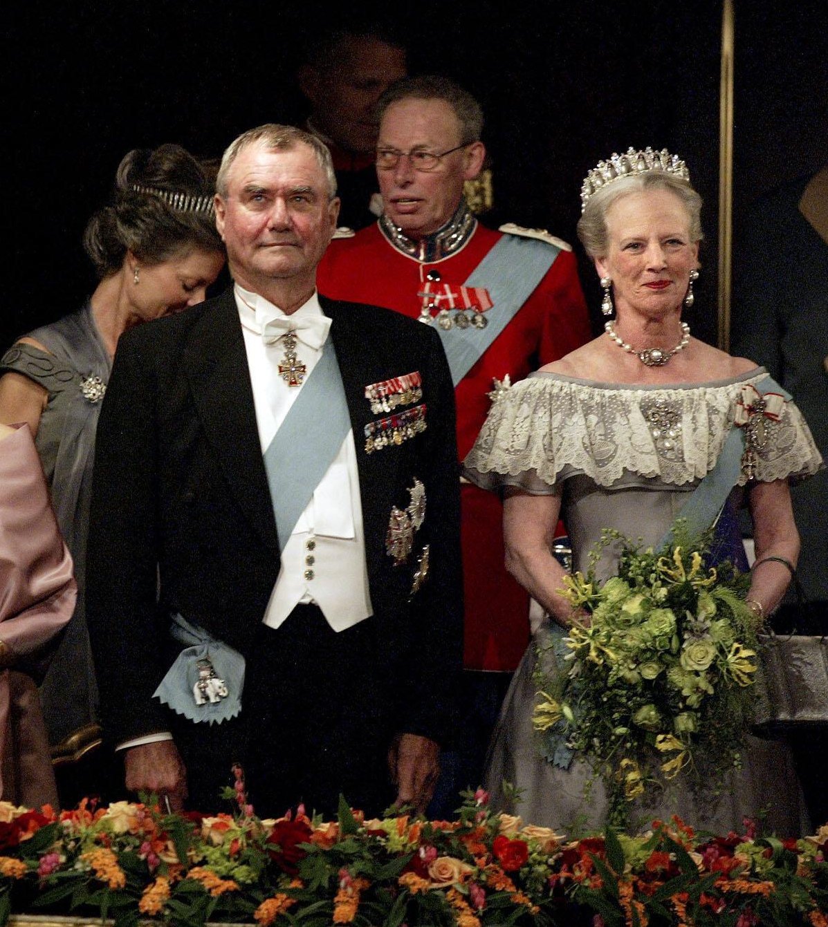Queen Margrethe II and Prince Henrik of Denmark, with Count Ingolf and Countess Sussie of Rosenborg sitting behind, attend a pre-wedding gala at the Royal Theatre in Copenhagen on May 13, 2004 (Polfoto/Ritzau/Alamy)