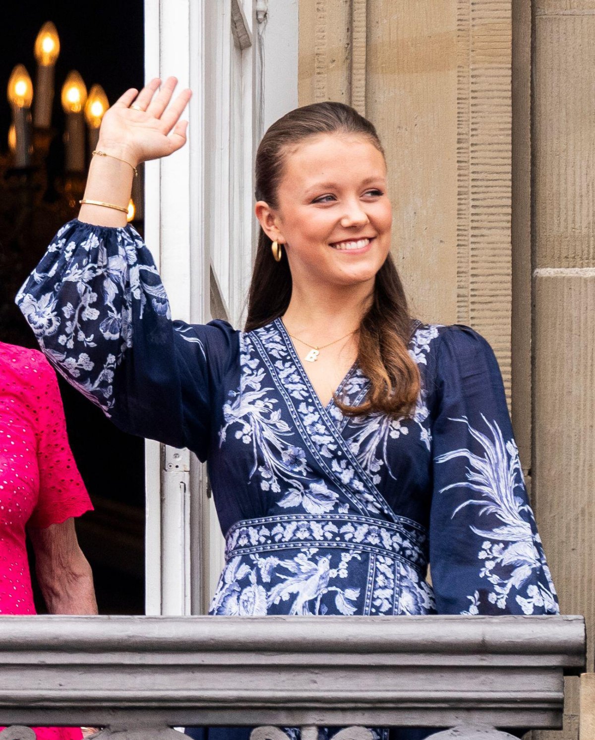 Princess Isabella of Denmark waves from the balcony of Frederik VIII's Palace at Amalienborg in Copenhagen during the celebrations of King Frederik X's birthday on May 26, 2024 (Ida Marie Odgaard/Ritzau Scanpix/Alamy)