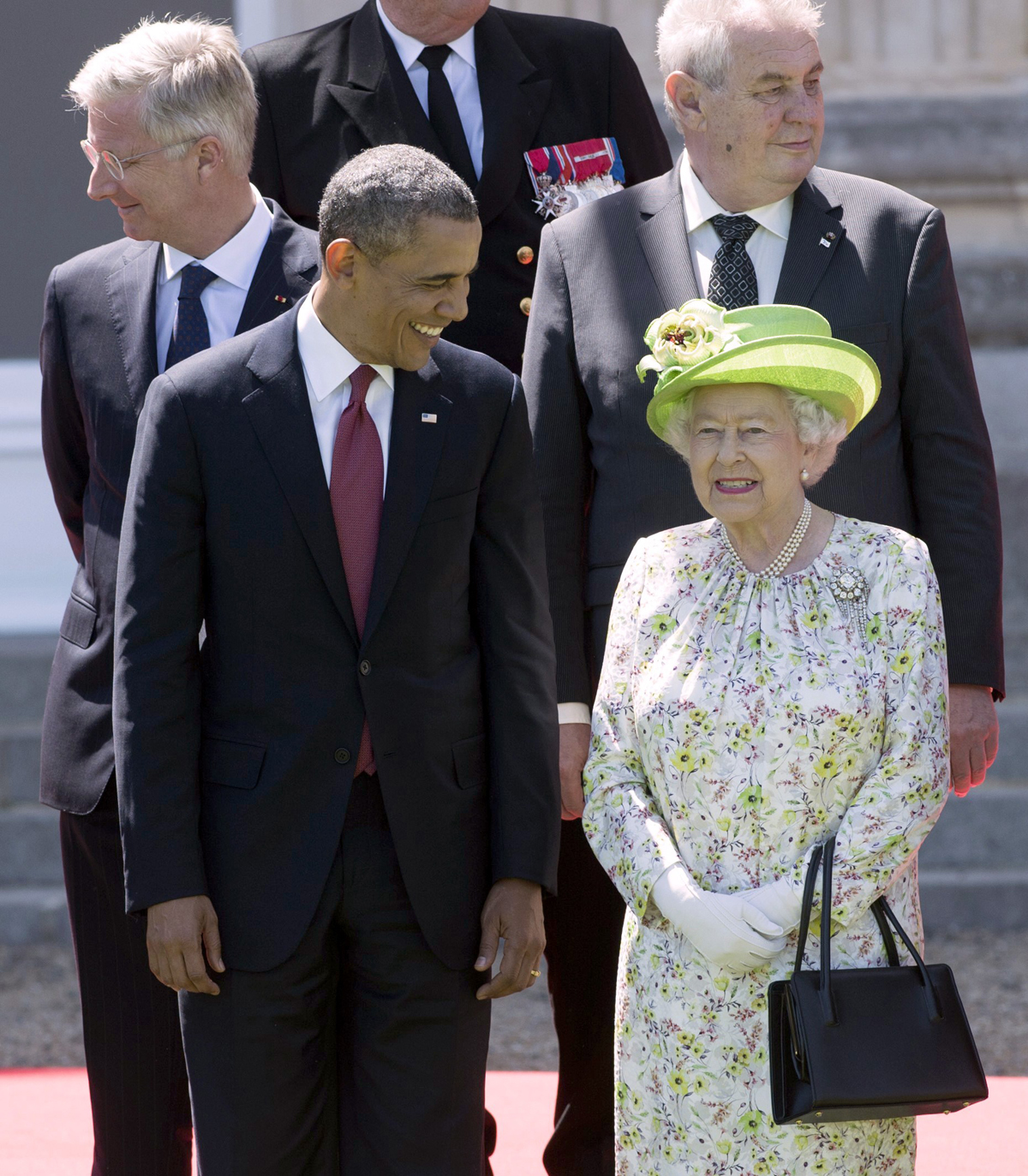 President Obama and Queen Elizabeth II pose for a group photo at Benouville Castle in France during the 70th anniversary commemorations of D-Day on June 6, 2014 (SAUL LOEB/AFP via Getty Images)