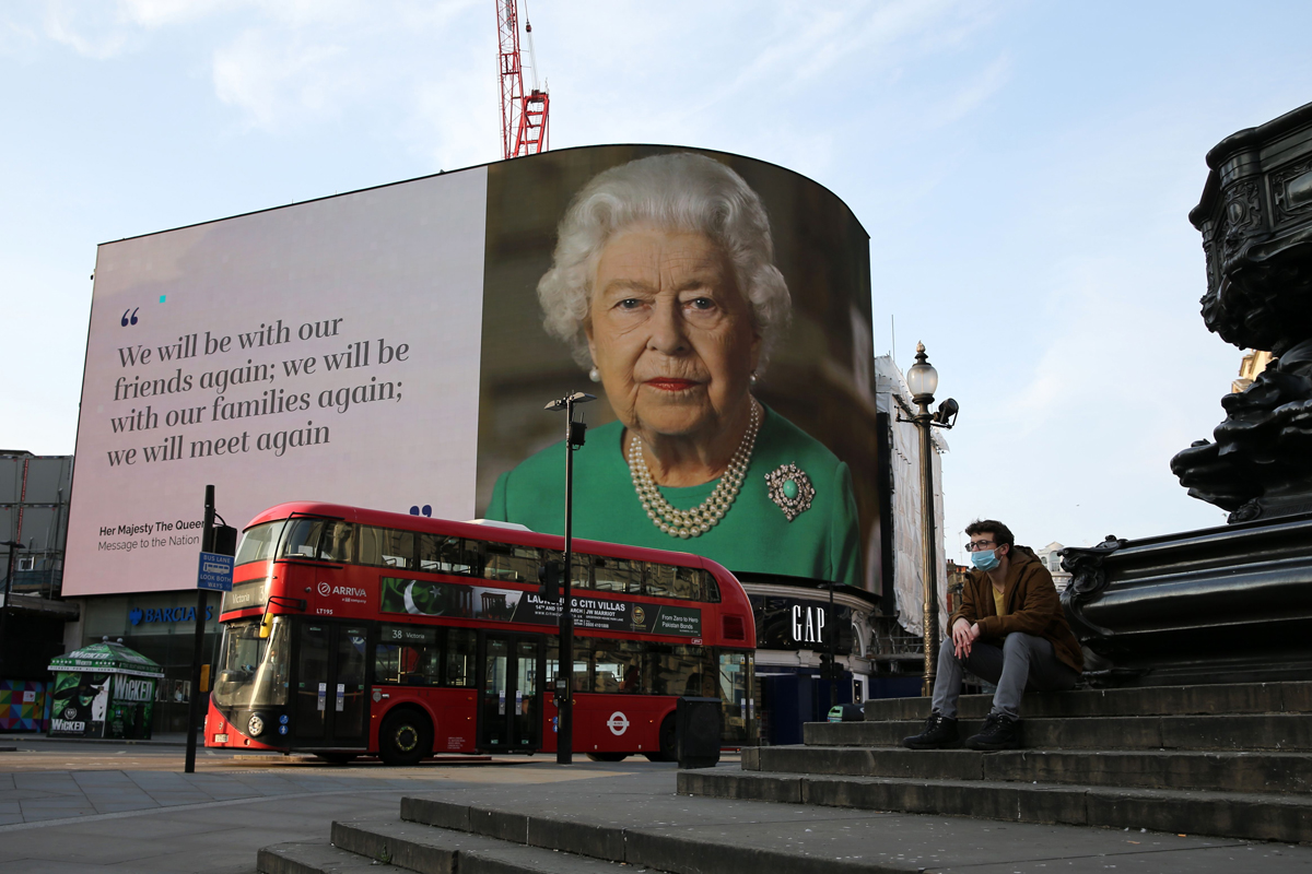 A still image from Queen Elizabeth II's special address to the nation regarding the pandemic is displayed in Piccadilly Circus in London on April 9, 2020 (ISABEL INFANTES/AFP via Getty Images)