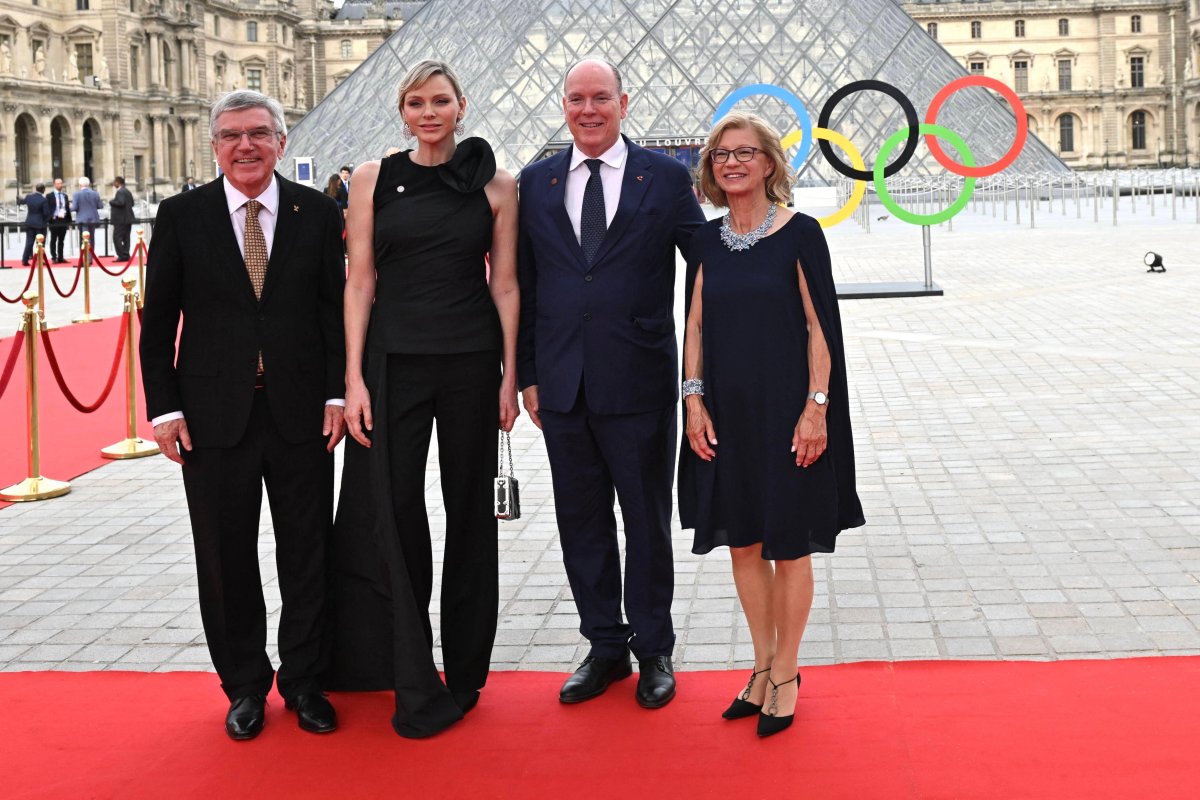 The Prince and Princess of Monaco are greeted by Thomas and Claudia Bach as they arrive for a gala dinner hosted by the International Olympic Committee and the French Presidency at the Louvre Museum in Paris on July 25, 2024 (Jeanne Accorsini/Abaca Press/Alamy)