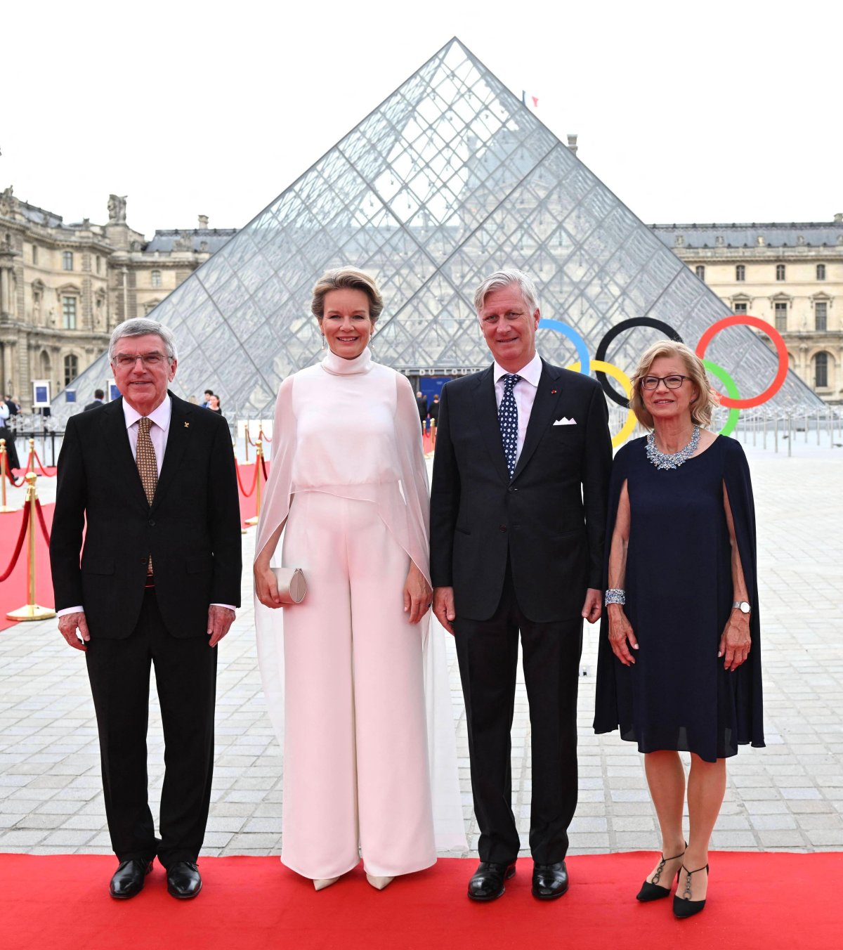 The King and Queen of the Belgians are greeted by Thomas and Claudia Bach as they arrive for a gala dinner hosted by the International Olympic Committee and the French Presidency at the Louvre Museum in Paris on July 25, 2024 (Jeanne Accorsini/Abaca Press/Alamy)