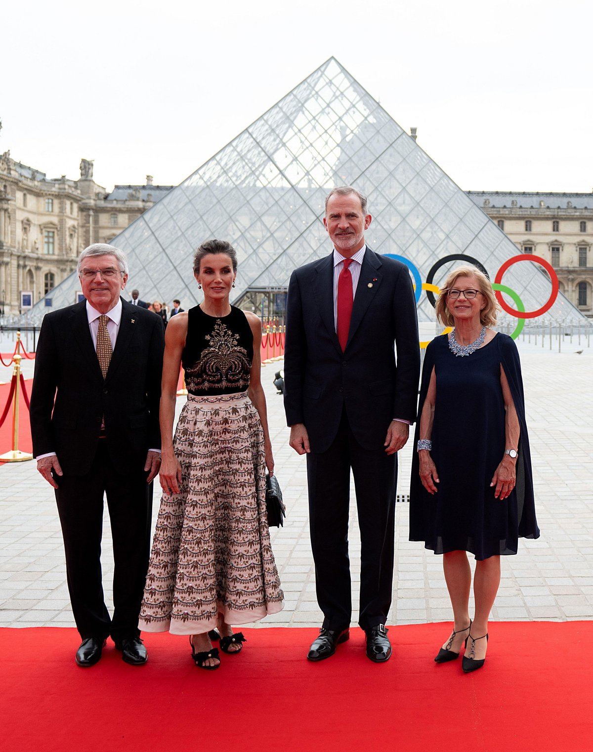 The King and Queen of Spain are greeted by Thomas and Claudia Bach as they arrive for a gala dinner hosted by the International Olympic Committee and the French Presidency at the Louvre Museum in Paris on July 25, 2024 (Jeanne Accorsini/Abaca Press/Alamy)