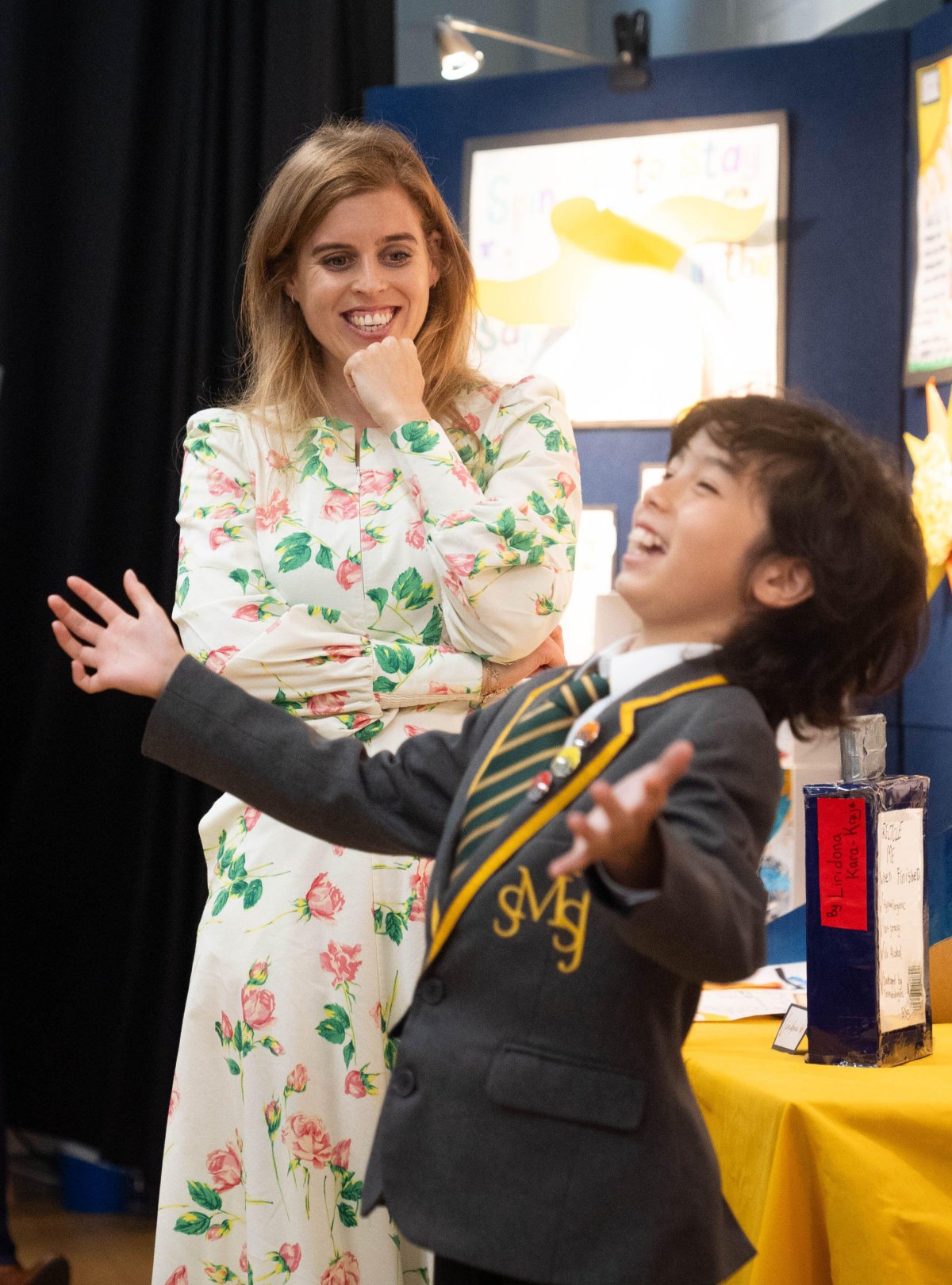 Princess Beatrice of York, patron of the British Skin Foundation, meets with pupils who have created sun safety posters during a visit to St. Mary's and St. John's primary school in north west London on July 23, 2024 (James Manning/PA Images/Alamy)
