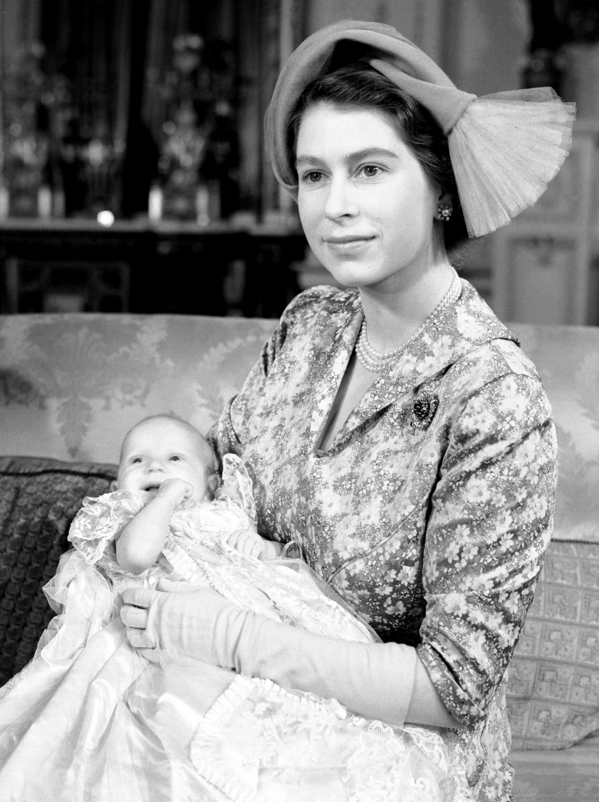 Princess Elizabeth, with Princess Anne, poses for portraits after the christening of Princess Anne at Buckingham Palace on October 21, 1950 (PA Images/Alamy)