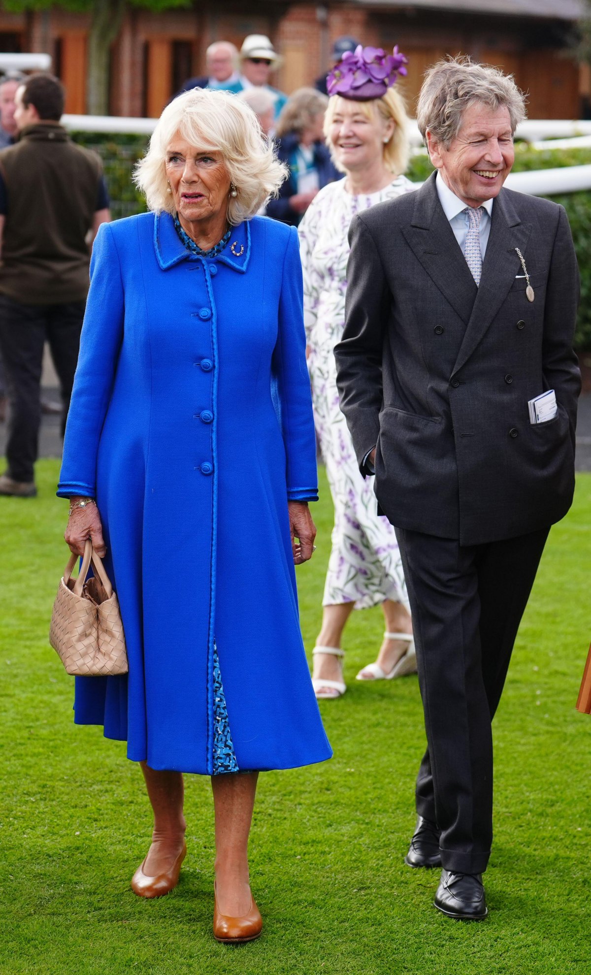 Queen Camilla, with royal racing manager John Warren, attends the third day of the Sky Bet Ebor Festival at York Racecourse on August 23, 2024 (Mike Egerton/PA Images/Alamy)