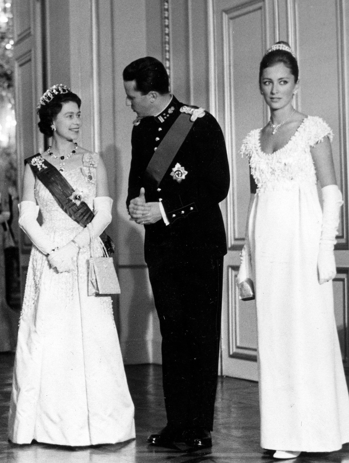 The Queen of the United Kingdom and the King of the Belgians, with the Princess of Liege, attend a state banquet at the Royal Palace in Brussels on May 9, 1966 (Belga News Agency/Alamy)