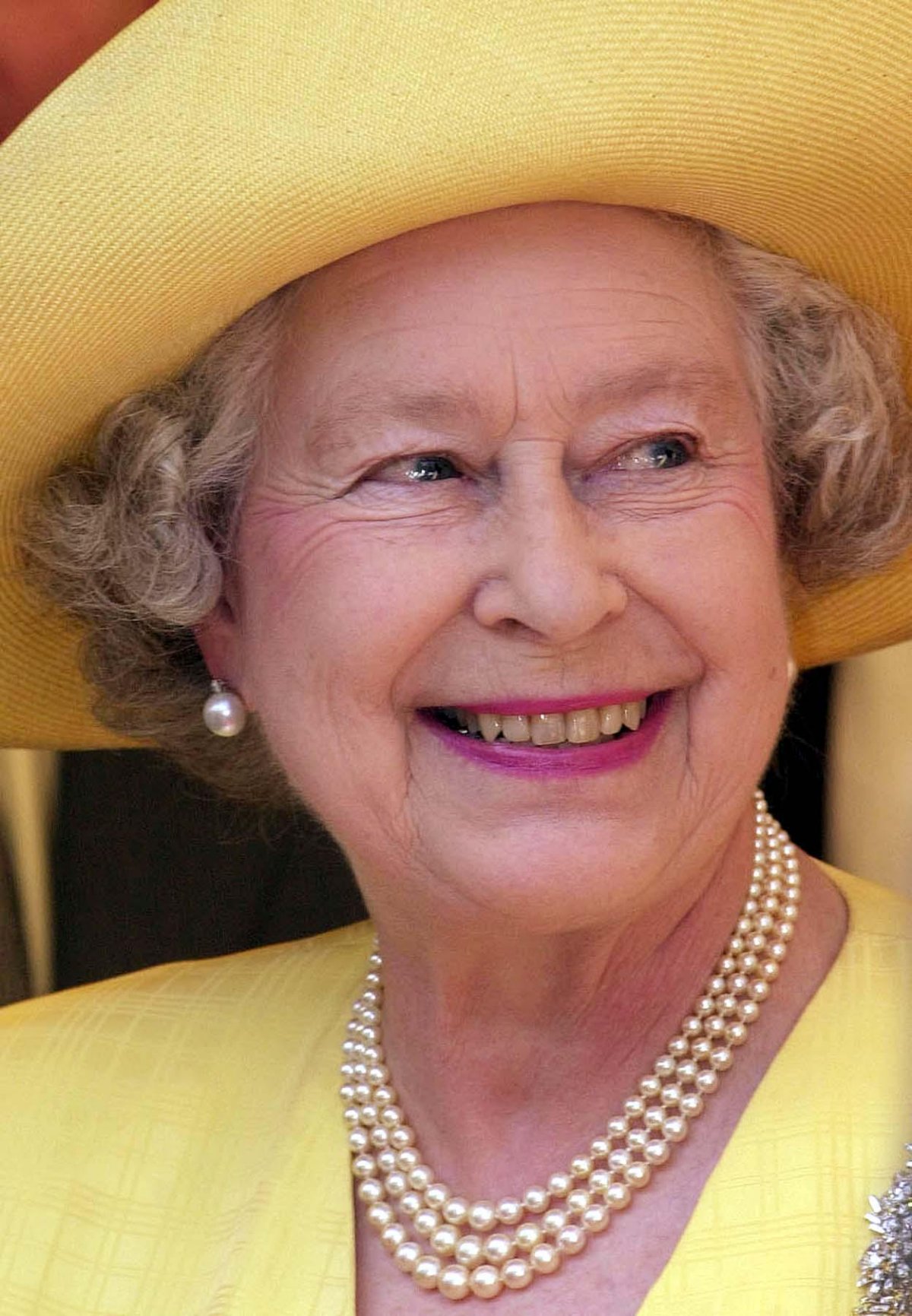 Queen Elizabeth II smiles after laying the foundation stone of the Memorial Gates, a monument to Indian, African and Caribbean World War volunteers, on Constitution Hill in London on August 1, 2001 (Fiona Hanson/PA Images/Alamy)