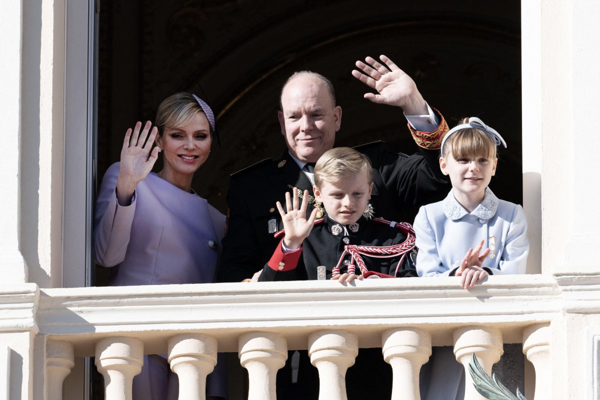The Prince and Princess of Monaco, with Hereditary Prince Jacques and Princess Gabriella, wave to the public from a palace balcony during the celebrations of Monaco's National Day on November 19, 2024 (David Niviere/Abaca Press/Alamy)