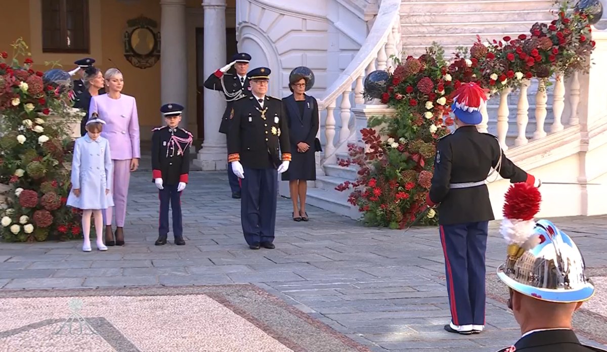 The Prince and Princess of Monaco, with Hereditary Prince Jacques, Princess Gabriella, Princess Caroline, and Princess Stephanie, stand in the palace courtyard to watch a military ceremony on Monaco's National Day on November 19, 2024 (Palais Princier de Monaco)
