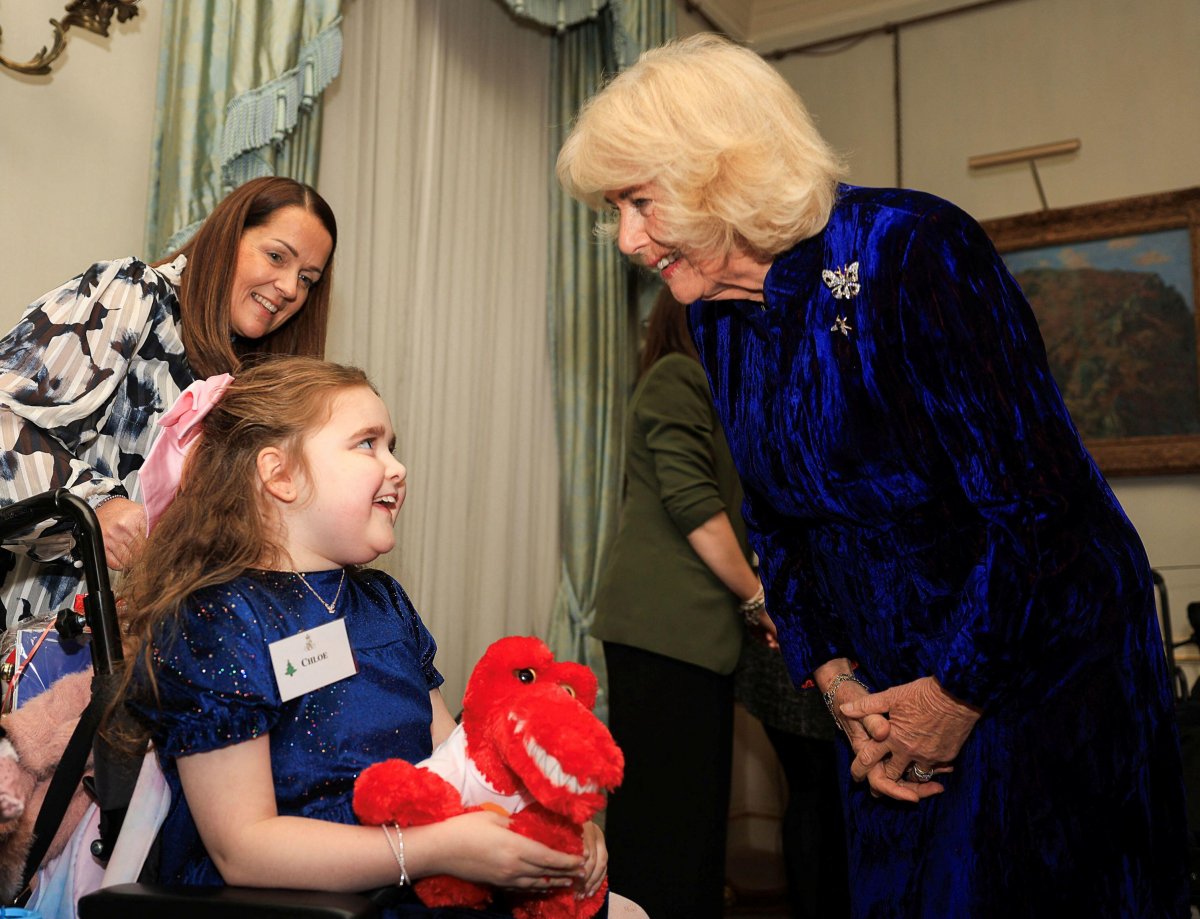 Queen Camilla hosts a Christmas party at Clarence House in London for parents and children supported by Helen & Douglas House and Roald Dahl's Marvellous Children's Charity on December 12, 2024 (Mina Kim/PA Images/Alamy)