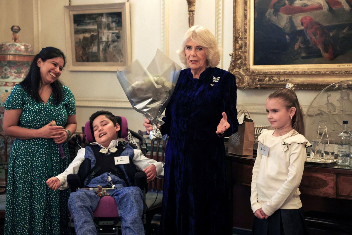 Queen Camilla hosts a Christmas party at Clarence House in London for parents and children supported by Helen & Douglas House and Roald Dahl's Marvellous Children's Charity on December 12, 2024 (Mina Kim/PA Images/Alamy)
