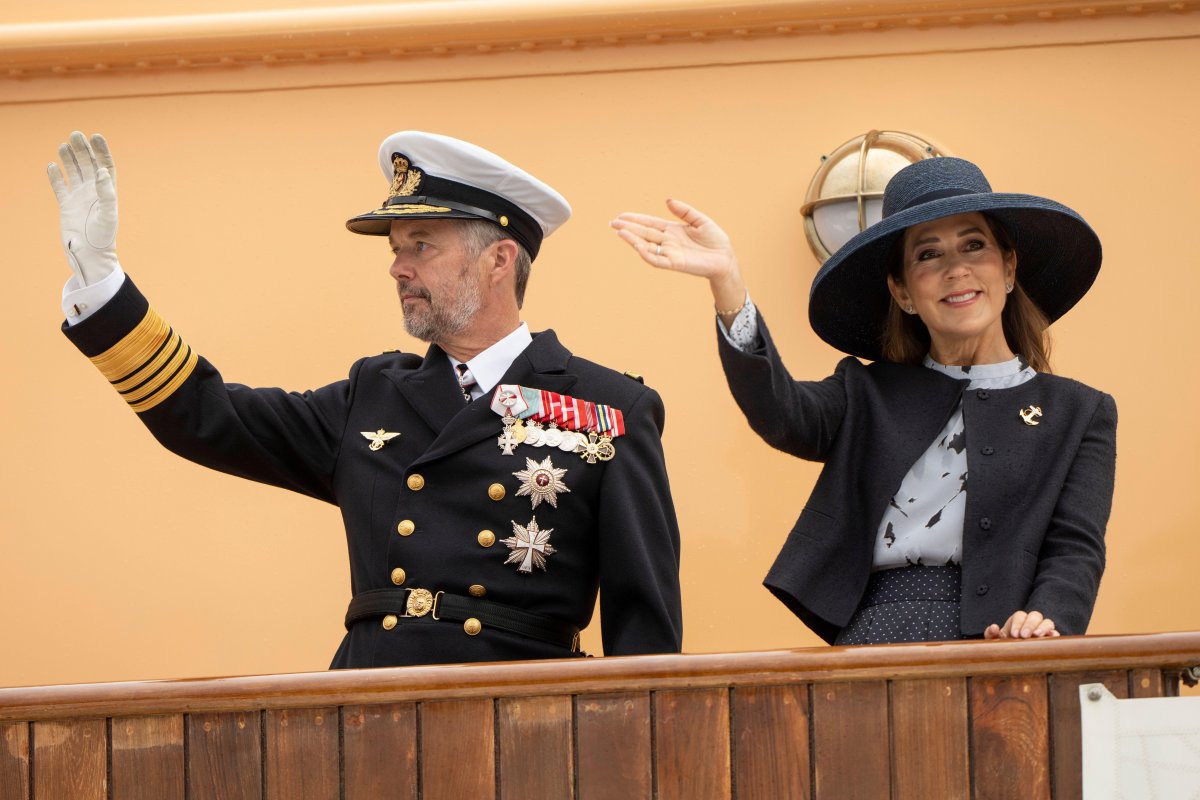 The King and Queen of Denmark wave during their summer tour aboard the Royal Yacht Dannebrog on August 22, 2024 (Bo Amstrup/Ritzau Scanpix/Alamy)